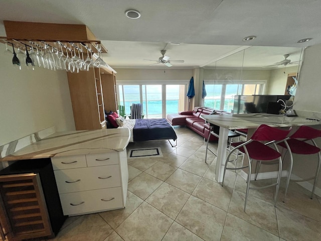 880 Mandalay Ave Unit N311, Clearwater Beach, FL 33767 - bedroom with access to exterior, light tile patterned flooring, and a ceiling fan