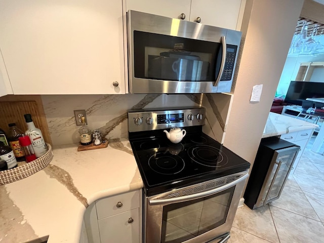 880 Mandalay Ave Unit N311, Clearwater Beach, FL 33767 - kitchen with appliances with stainless steel finishes, light countertops, and white cabinets