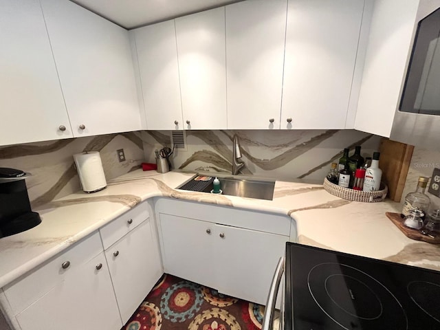 880 Mandalay Ave Unit N311, Clearwater Beach, FL 33767 - kitchen featuring white cabinetry and electric range oven