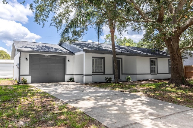 22716 Penny Loop, Land O Lakes, FL 34639 - ranch-style house with stucco siding, an attached garage, concrete driveway, and roof with shingles