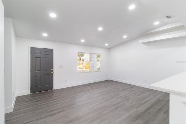 22716 Penny Loop, Land O Lakes, FL 34639 - unfurnished living room featuring wood finished floors, recessed lighting, and lofted ceiling