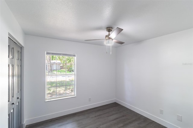22716 Penny Loop, Land O Lakes, FL 34639 - unfurnished room featuring a ceiling fan, dark wood-type flooring, and a textured ceiling