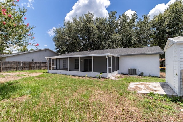 22716 Penny Loop, Land O Lakes, FL 34639 - rear view of house featuring a sunroom and stucco siding