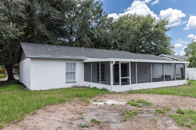 22716 Penny Loop, Land O Lakes, FL 34639 - back of property with a sunroom, roof with shingles, and stucco siding