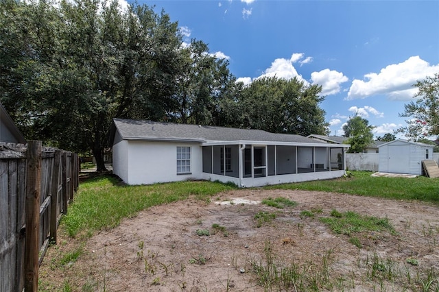 22716 Penny Loop, Land O Lakes, FL 34639 - back of house featuring a sunroom, a storage unit, and stucco siding