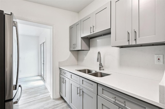607 E River Dr, Temple Terrace, FL 33617 - kitchen featuring freestanding refrigerator, gray cabinetry, light countertops, and light wood-style floors
