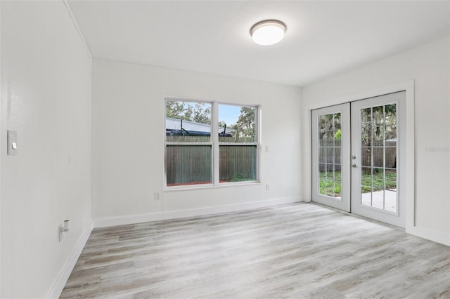 607 E River Dr, Temple Terrace, FL 33617 - spare room featuring french doors and light wood-style floors