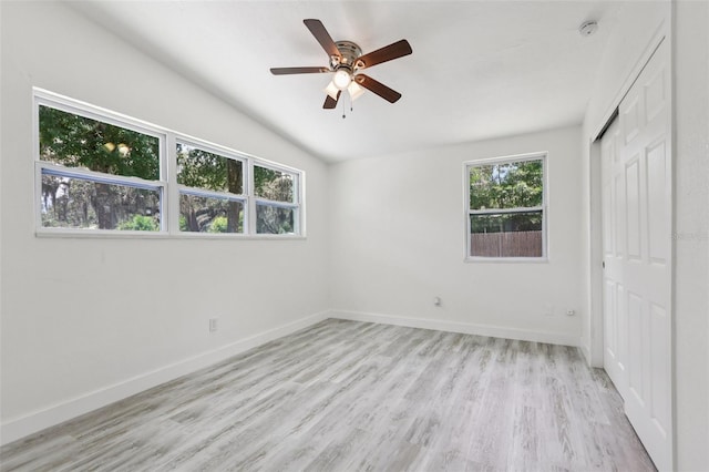 607 E River Dr, Temple Terrace, FL 33617 - unfurnished bedroom with a closet, light wood-style floors, vaulted ceiling, and a ceiling fan