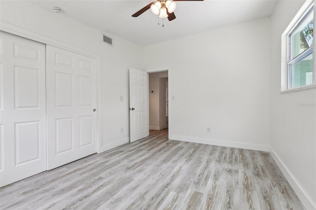 607 E River Dr, Temple Terrace, FL 33617 - unfurnished bedroom with light wood-style floors, a closet, and a ceiling fan