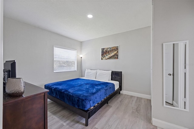 1048 W Lime St, Lakeland, FL 33815 - bedroom featuring light wood-style flooring and baseboards