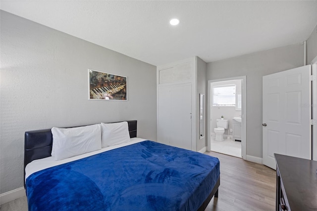 1048 W Lime St, Lakeland, FL 33815 - bedroom featuring light wood-style flooring and connected bathroom