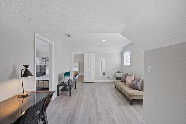 1048 W Lime St, Lakeland, FL 33815 - sitting room with light wood-type flooring, a textured ceiling, and lofted ceiling