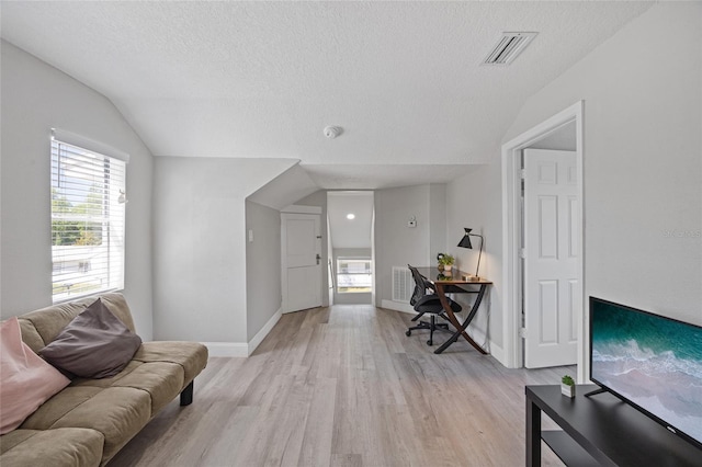 1048 W Lime St, Lakeland, FL 33815 - living area with lofted ceiling, light wood-style flooring, an office area, and a textured ceiling