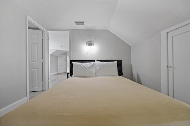 1048 W Lime St, Lakeland, FL 33815 - unfurnished bedroom with lofted ceiling and wood finished floors