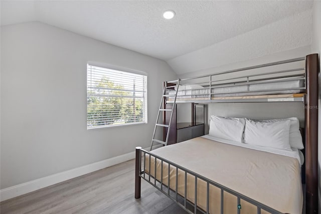 1048 W Lime St, Lakeland, FL 33815 - bedroom with vaulted ceiling, wood finished floors, a textured ceiling, and recessed lighting