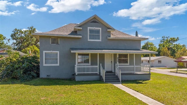 1048 W Lime St, Lakeland, FL 33815 - view of front of property featuring covered porch, stucco siding, a shingled roof, and a front yard