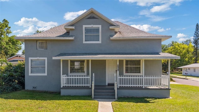 1048 W Lime St, Lakeland, FL 33815 - view of front of home featuring a porch, stucco siding, a shingled roof, and a front lawn