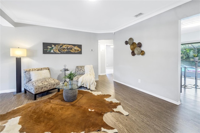 610 Cordova Blvd NE, Saint Petersburg, FL 33704 - sitting room with wood finished floors and crown molding