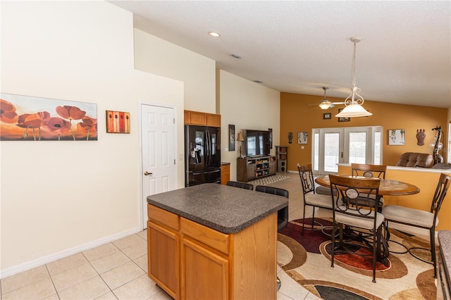 643 Blenheim Loop, Winter Springs, FL 32708 - kitchen with black fridge, dark countertops, a ceiling fan, open floor plan, and a center island