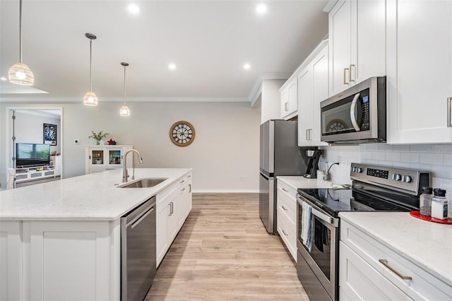 6879 Talamore Dr, Wesley Chapel, FL 33545 - kitchen featuring stainless steel appliances, a kitchen island with sink, ornamental molding, white cabinets, and backsplash