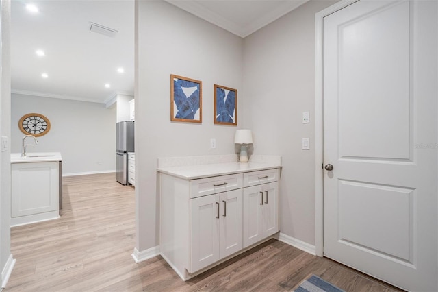 6879 Talamore Dr, Wesley Chapel, FL 33545 - hall featuring crown molding, light wood-type flooring, and recessed lighting