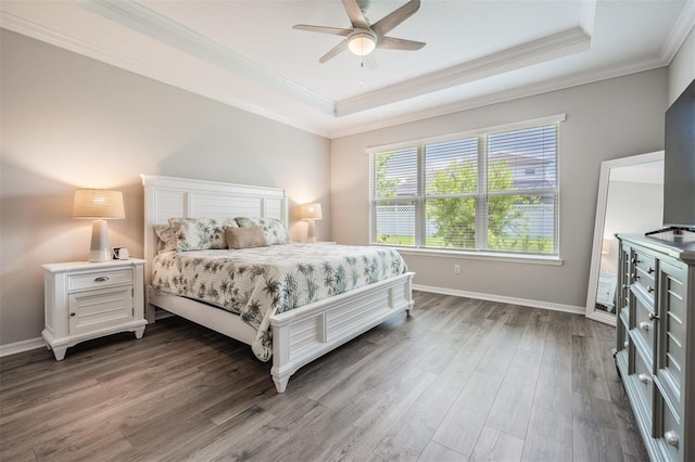 6879 Talamore Dr, Wesley Chapel, FL 33545 - bedroom featuring a raised ceiling, dark wood finished floors, crown molding, and a ceiling fan