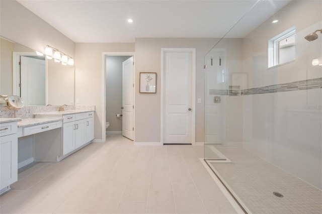 6879 Talamore Dr, Wesley Chapel, FL 33545 - bathroom featuring a walk in shower, vanity, tile patterned flooring, and recessed lighting