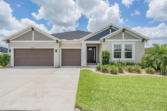 6879 Talamore Dr, Wesley Chapel, FL 33545 - view of front of property featuring stucco siding, concrete driveway, and a front yard