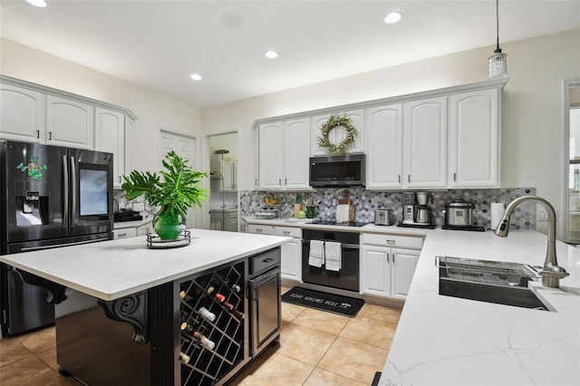 13503 Gopher Pond Ct, Hudson, FL 34669 - kitchen with stainless steel appliances, tasteful backsplash, light stone counters, white cabinetry, and recessed lighting