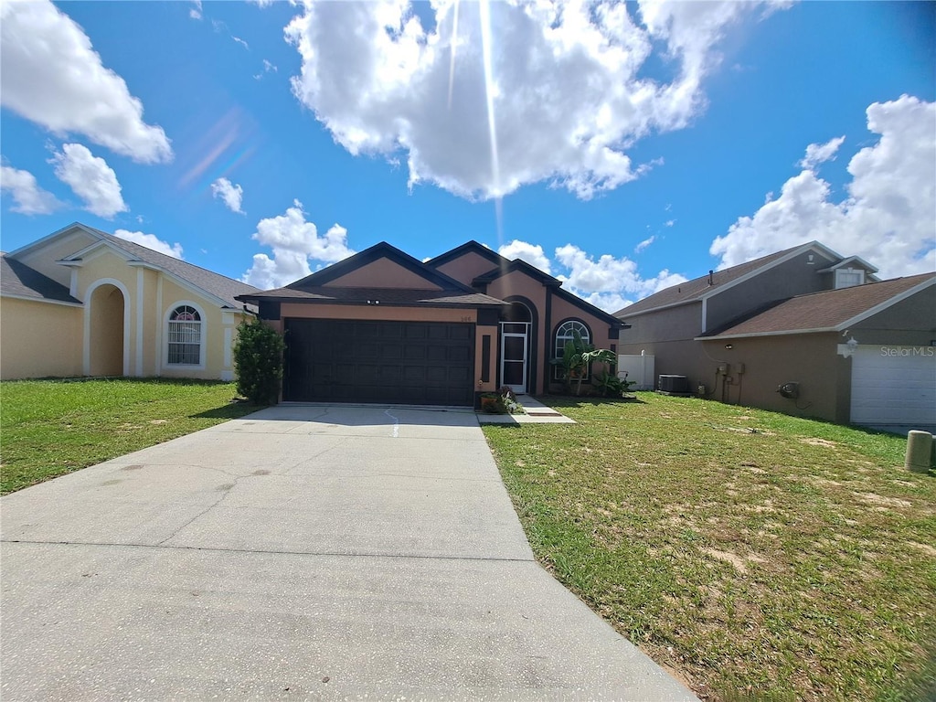 506 Nicholson Dr, Davenport, FL 33837 - ranch-style home with driveway, a garage, a front yard, and stucco siding