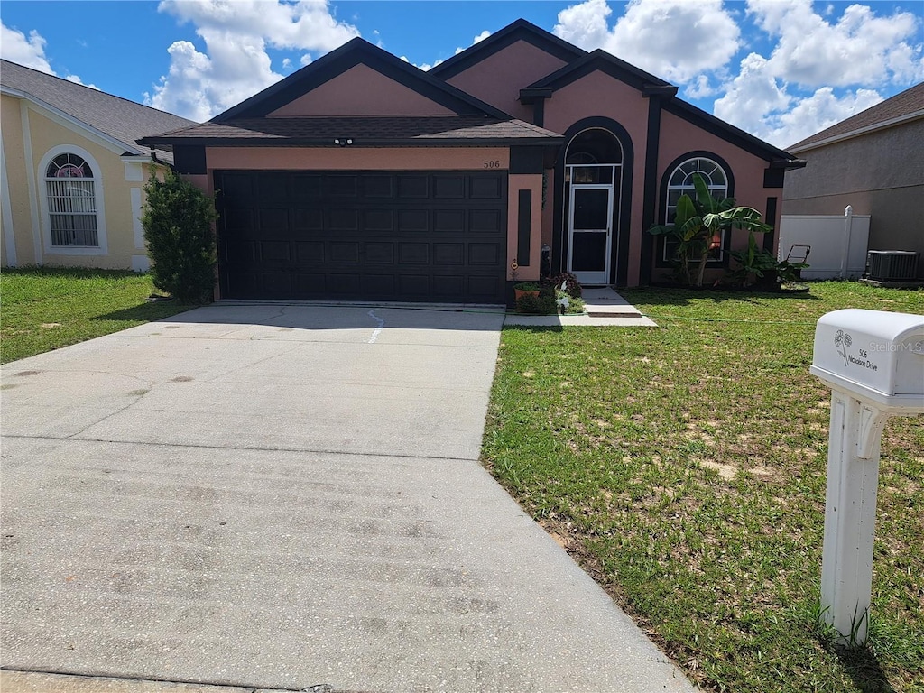 506 Nicholson Dr, Davenport, FL 33837 - ranch-style house with a front lawn, stucco siding, concrete driveway, and an attached garage