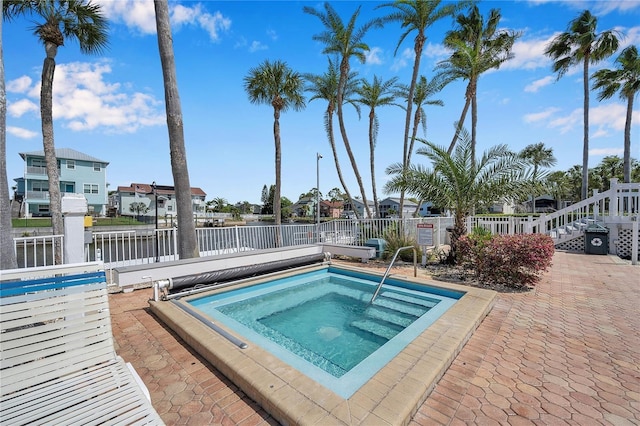 5722 Biscayne Ct Unit 107, New Port Richey, FL 34652 - view of pool featuring a community hot tub, a water view, and a residential view
