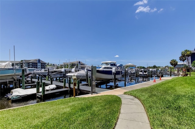 5722 Biscayne Ct Unit 107, New Port Richey, FL 34652 - dock featuring boat lift, a lawn, and a water view