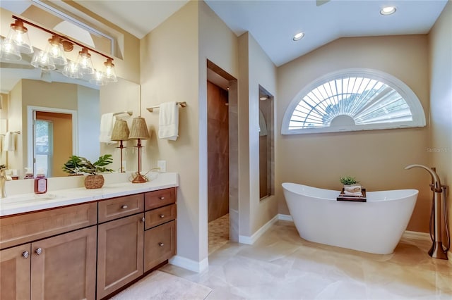 1827 Foxboro Ct, Oldsmar, FL 34677 - bathroom with vanity, a freestanding tub, walk in shower, recessed lighting, and lofted ceiling