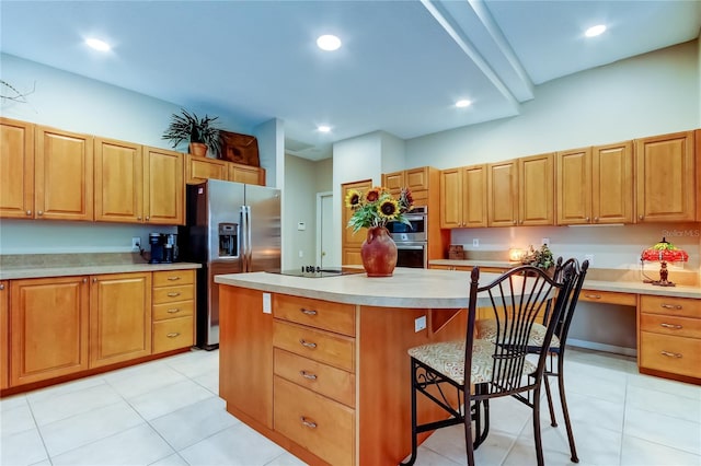 1827 Foxboro Ct, Oldsmar, FL 34677 - kitchen with appliances with stainless steel finishes, a breakfast bar area, a kitchen island, light countertops, and light tile patterned floors