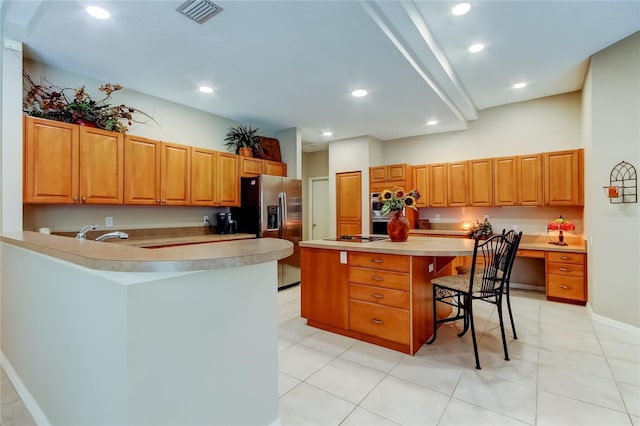 1827 Foxboro Ct, Oldsmar, FL 34677 - kitchen featuring stainless steel fridge, a breakfast bar, light countertops, a kitchen island, and recessed lighting