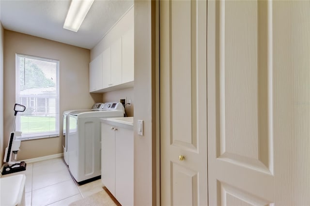 1827 Foxboro Ct, Oldsmar, FL 34677 - washroom featuring cabinet space, separate washer and dryer, and light tile patterned floors