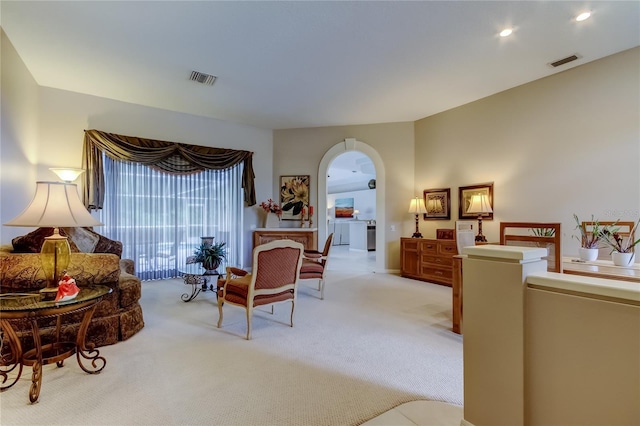 1827 Foxboro Ct, Oldsmar, FL 34677 - living room featuring arched walkways, light colored carpet, and recessed lighting