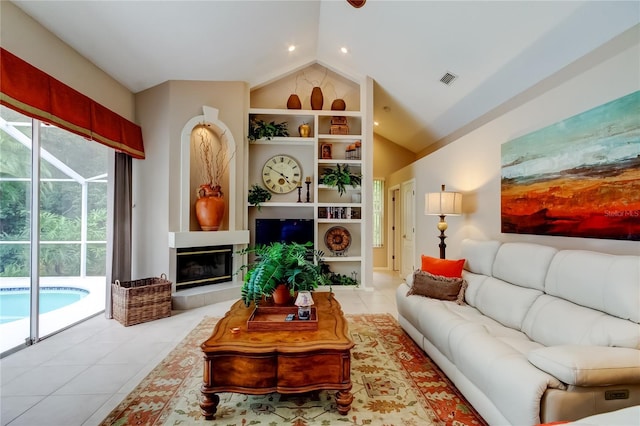 1827 Foxboro Ct, Oldsmar, FL 34677 - tiled living room with built in features, vaulted ceiling, a glass covered fireplace, and recessed lighting