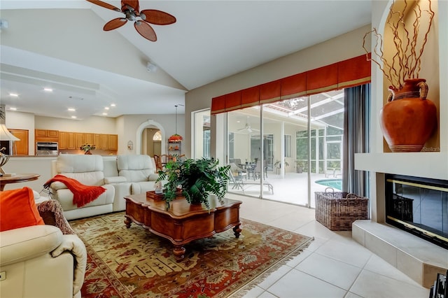 1827 Foxboro Ct, Oldsmar, FL 34677 - living room with ceiling fan, light tile patterned floors, arched walkways, a glass covered fireplace, and recessed lighting