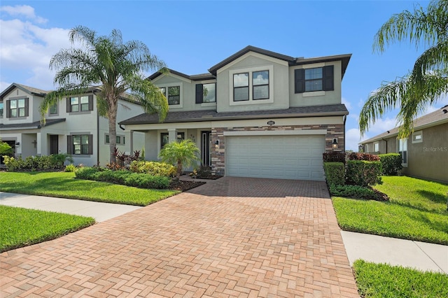 19209 Long Lake Ranch Blvd, Lutz, FL 33558 - view of front of home featuring decorative driveway, a garage, stucco siding, and a front yard