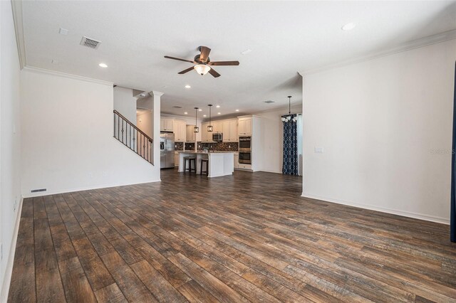 19209 Long Lake Ranch Blvd, Lutz, FL 33558 - unfurnished living room with ornamental molding, ceiling fan, dark wood-style floors, recessed lighting, and stairs