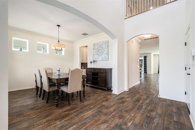 19209 Long Lake Ranch Blvd, Lutz, FL 33558 - dining space with dark wood-style flooring, crown molding, and arched walkways