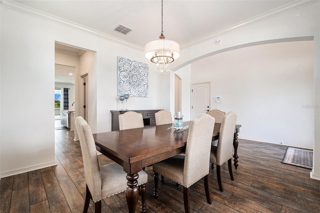 19209 Long Lake Ranch Blvd, Lutz, FL 33558 - dining area featuring arched walkways, dark wood-style floors, crown molding, and a chandelier