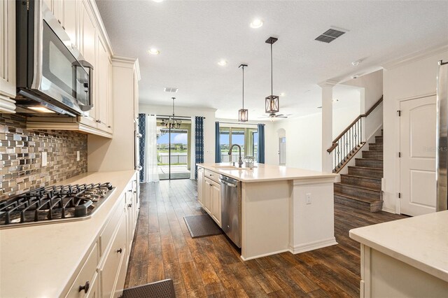 19209 Long Lake Ranch Blvd, Lutz, FL 33558 - kitchen featuring appliances with stainless steel finishes, dark wood-style flooring, decorative backsplash, light countertops, and recessed lighting