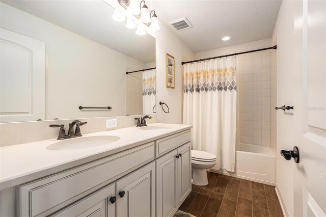19209 Long Lake Ranch Blvd, Lutz, FL 33558 - full bathroom with double vanity, wood finished floors, shower / tub combo with curtain, a textured ceiling, and recessed lighting