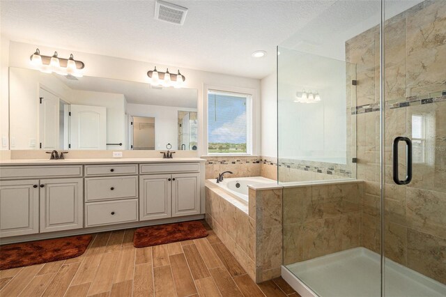 19209 Long Lake Ranch Blvd, Lutz, FL 33558 - full bath with a shower stall, double vanity, a garden tub, wood tiled floors, and recessed lighting