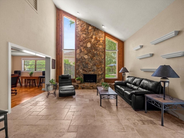 4118 Carrollwood Village Dr, Tampa, FL 33618 - living area with stone tile floors, high vaulted ceiling, and a stone fireplace