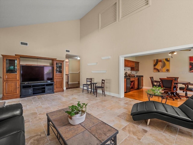 4118 Carrollwood Village Dr, Tampa, FL 33618 - living room featuring stone tile floors and high vaulted ceiling