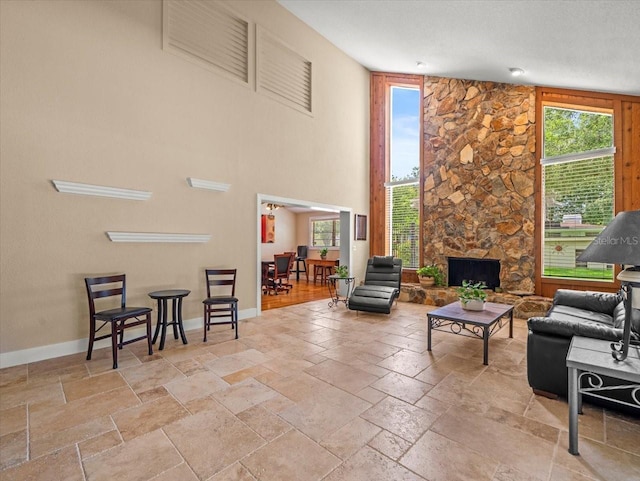 4118 Carrollwood Village Dr, Tampa, FL 33618 - living room with stone tile flooring, plenty of natural light, a towering ceiling, and a fireplace